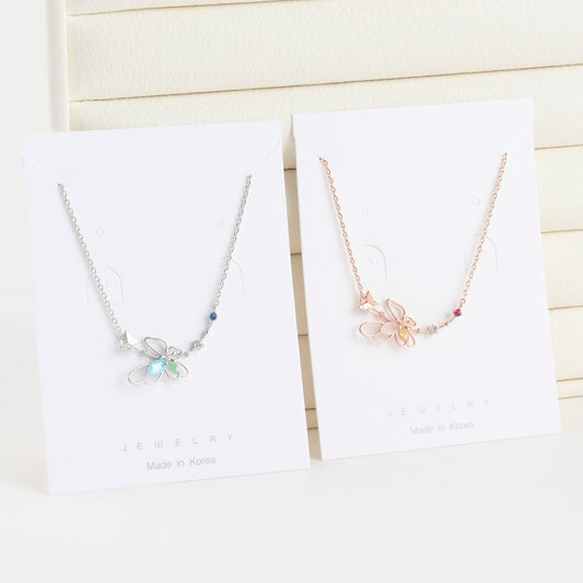 Two butterfly-themed necklaces on white cards with 'Made in Korea' text.