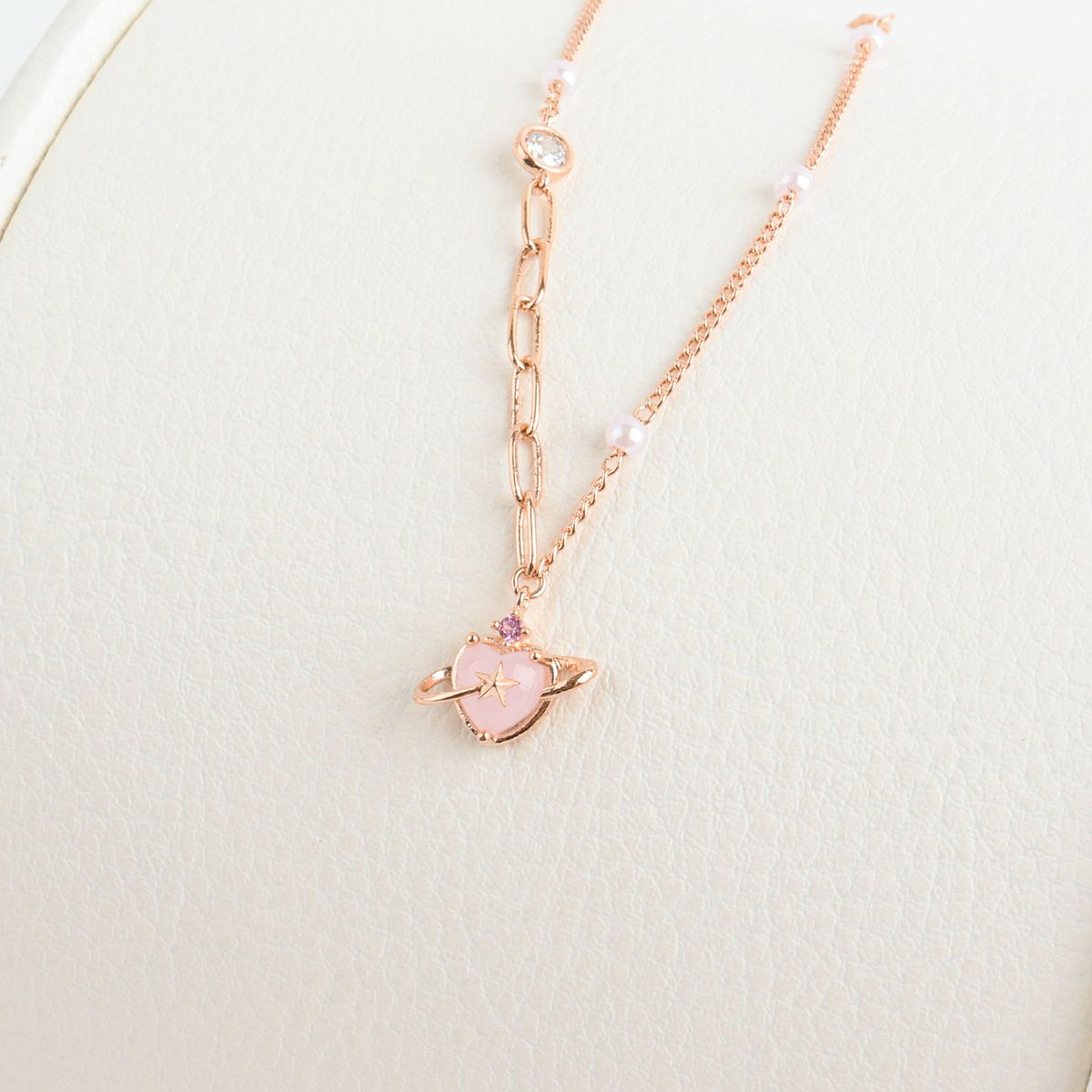 Necklace with a pink heart pendant on a light background
