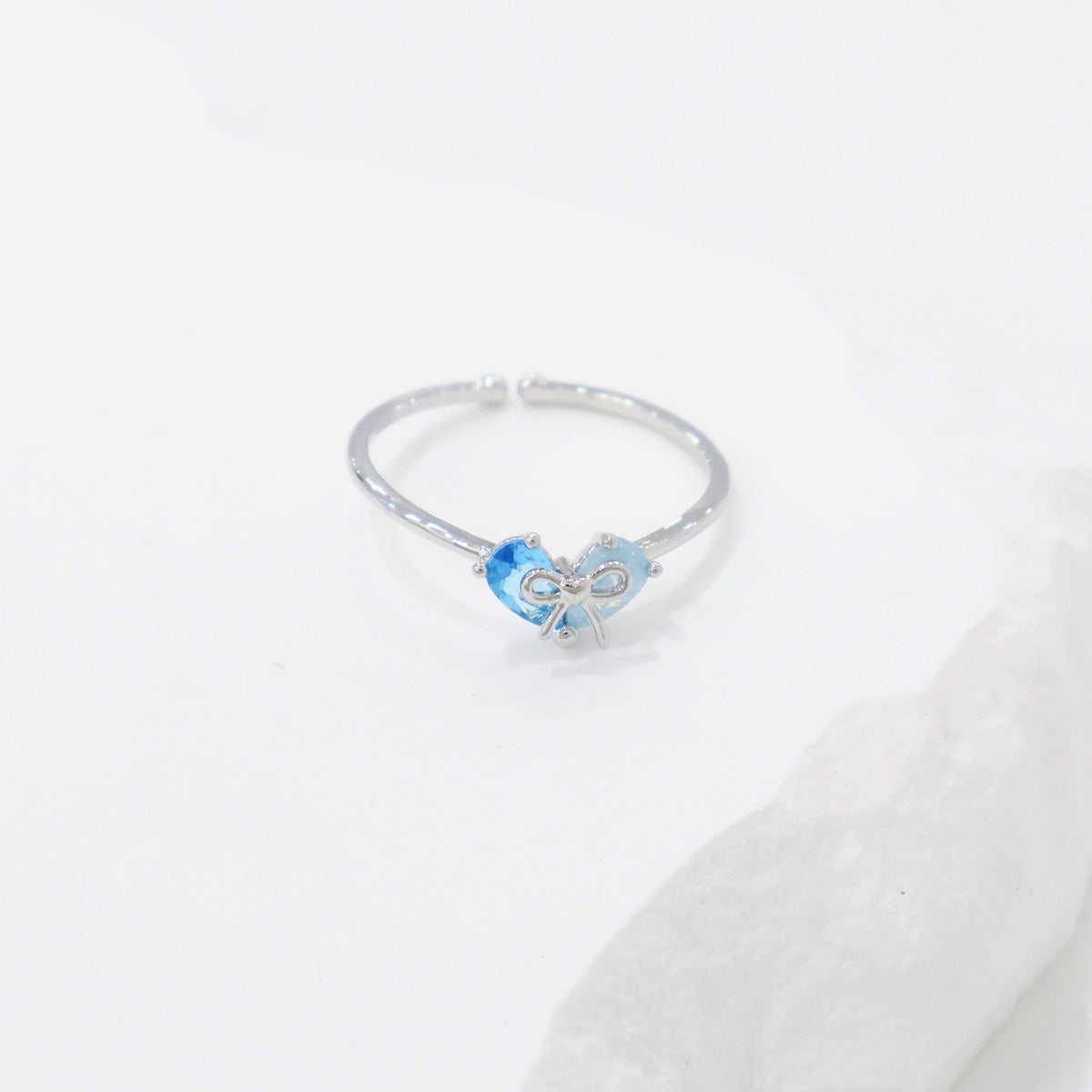 Silver ring with a blue gemstone on a white background