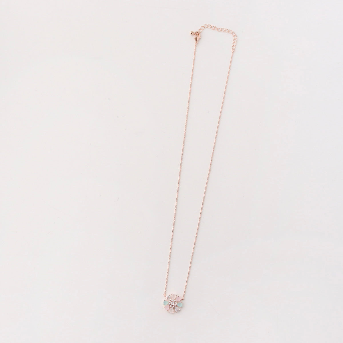 Necklace with a floral pendant on a light gray background