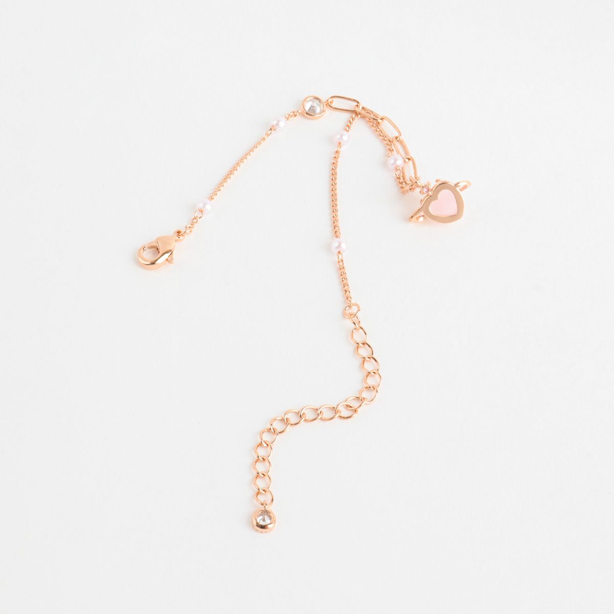 Rose gold bracelet on a light gray background