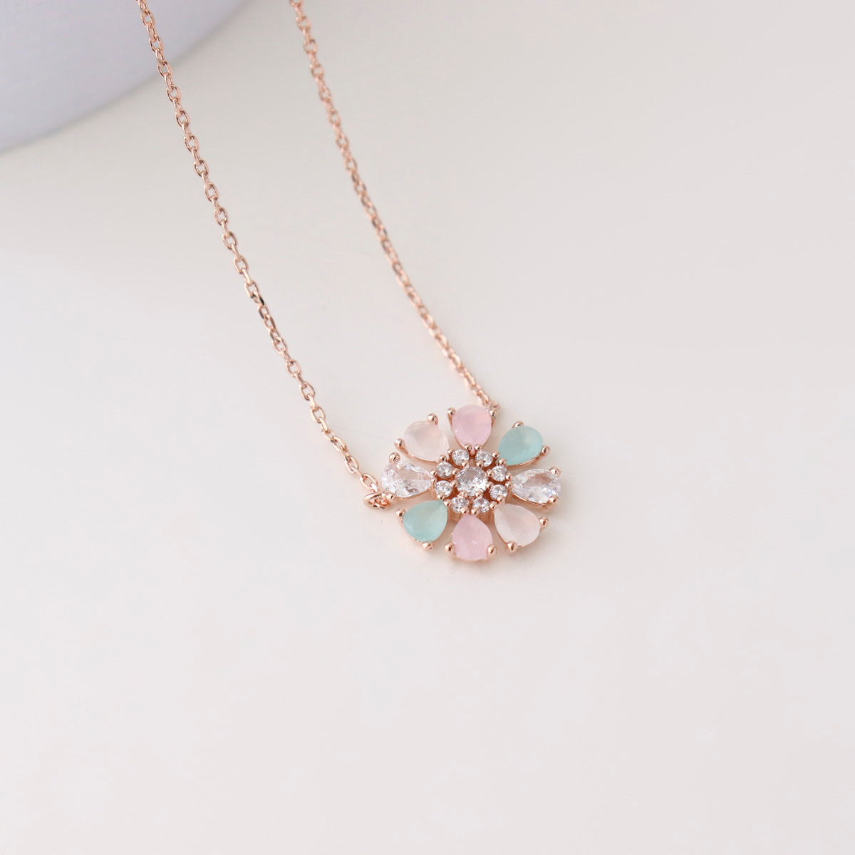 Necklace with a floral pendant on a light gray background