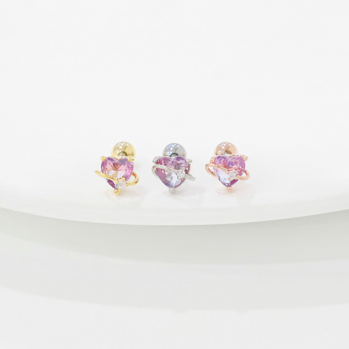 Heart-shaped earrings with purple gemstones on a white background