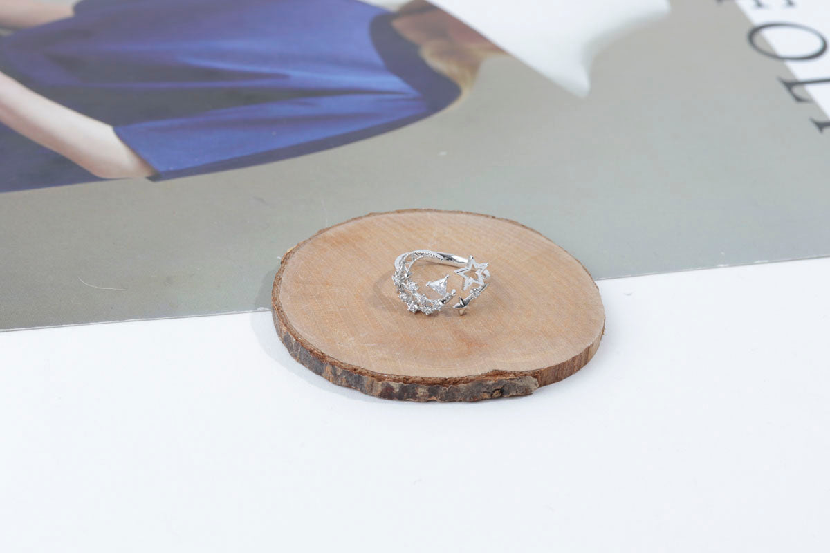 Silver ring on a wooden stand with a blurred background